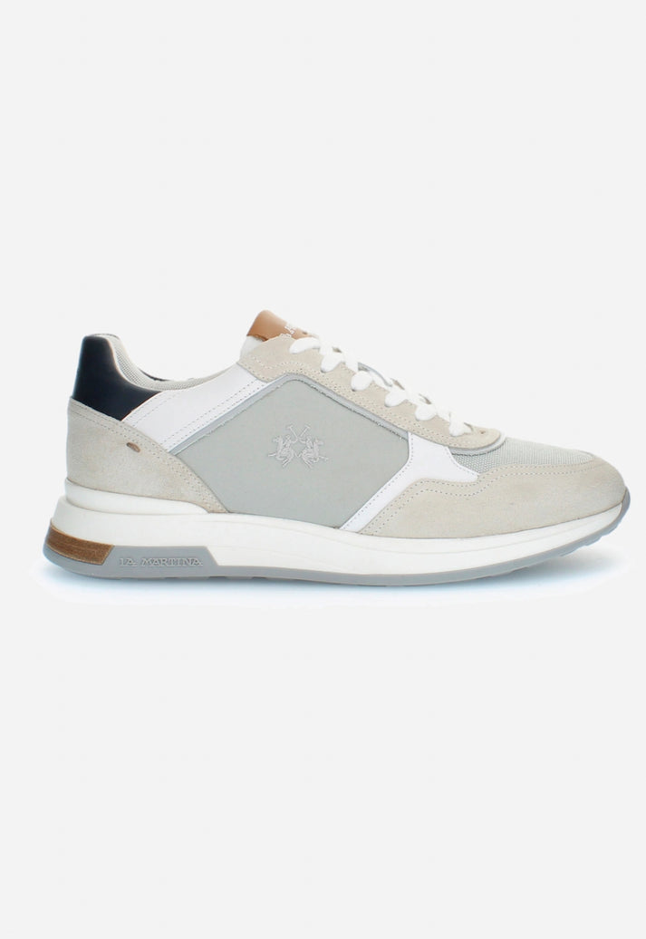 White sneaker with gray patch on a white background
