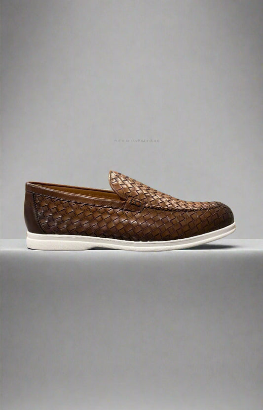 Brown woven loafer with white sole on a gray surface