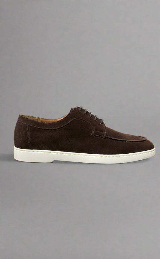 Brown suede shoe on a gray background