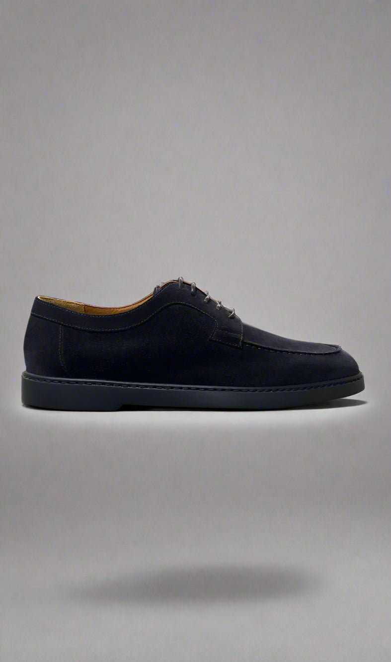 Black suede shoe on a gray background