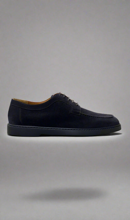 Black suede shoe on a gray background
