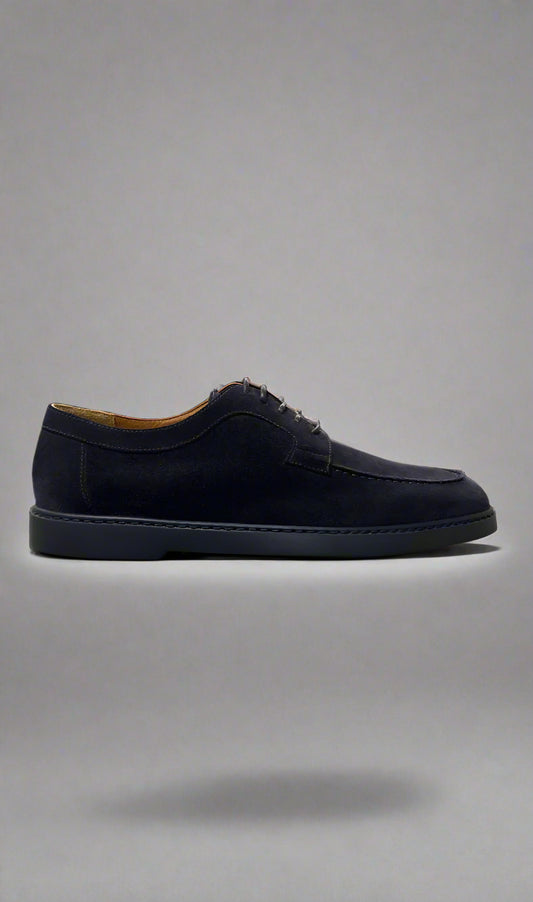 Black suede shoe on a gray background