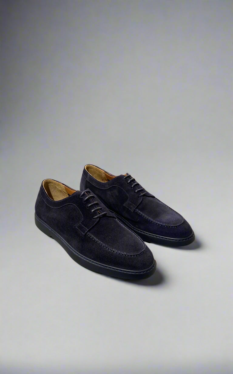 Pair of black suede shoes on a light gray background