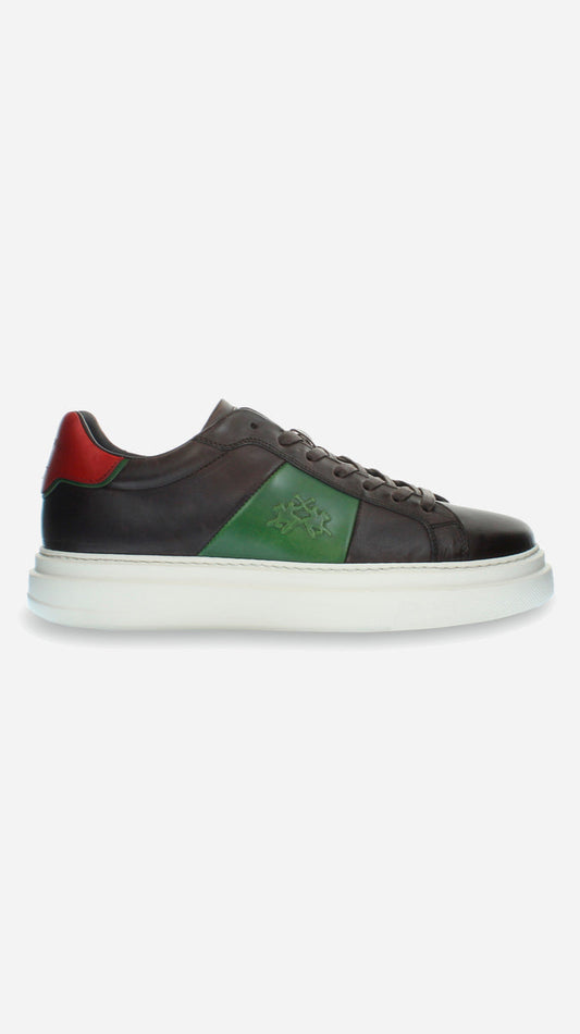 Black sneaker with red and green accents on a white background